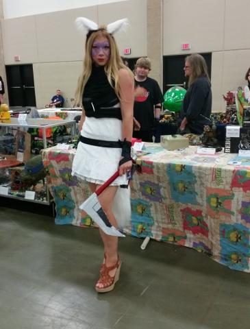 Alopex at the Cowabunga Corner booth.  Leatherhead and Robbie Rist in the booth behind her at Fandom Fest 2015.